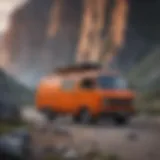 Bright orange van parked in front of a rugged mountain