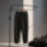 Minimalist black sweatpants on hanger