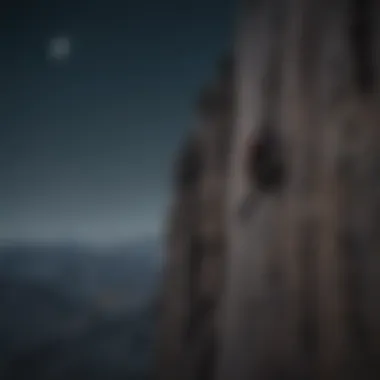 A climber scaling a mountain with the crescent moon in the background