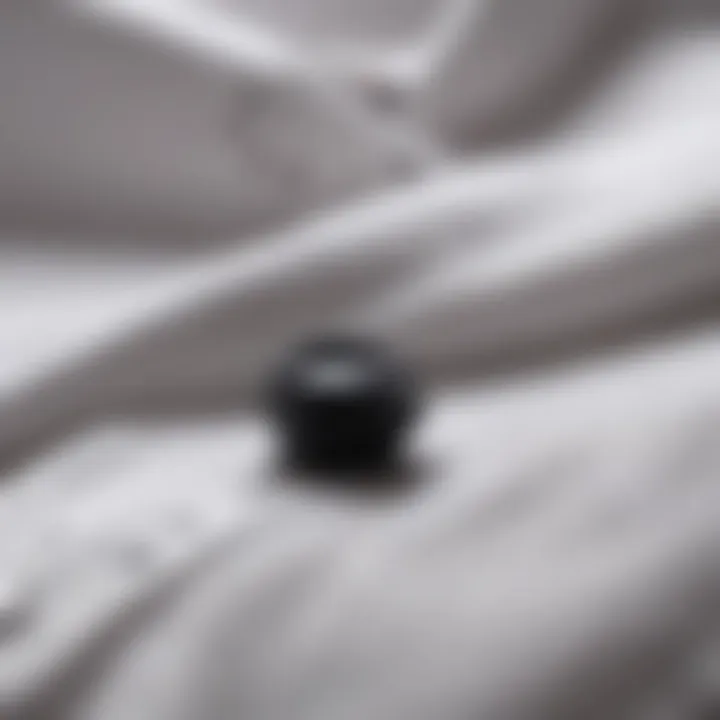 Close-up of black buttons on a crisp white shirt