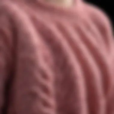 Close-up of intricate chenille knit pattern in pink sweater