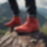 Vibrant crimson all-red shoes against a backdrop of rugged mountain terrain