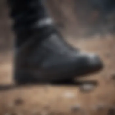 Close-up of black leather Nike shoe on rocky terrain with motion blur