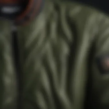 Fabric Texture and Detailing of the Bomber Jacket Close-up of the fabric texture and detailing of an army green bomber jacket.