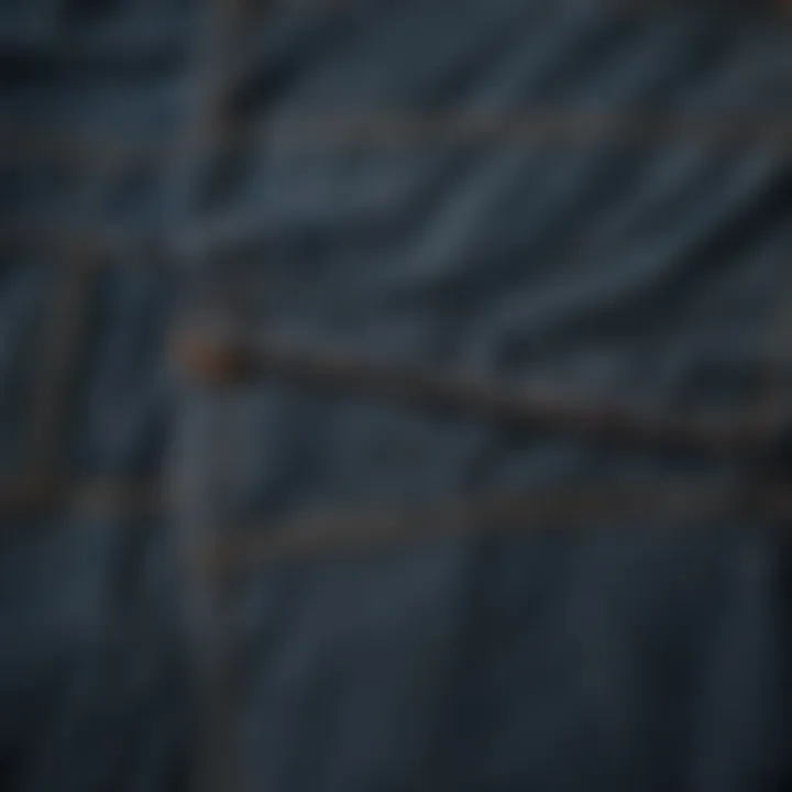 A close-up of the intricate fabric and stitching of baggy denim overalls.