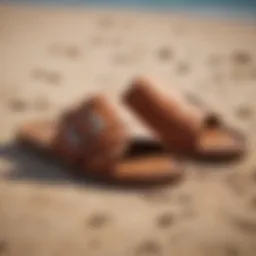 Stylish cognac slide sandals on a sandy beach