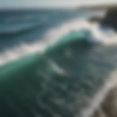 Aerial view of a breathtaking coastline with surfers catching waves