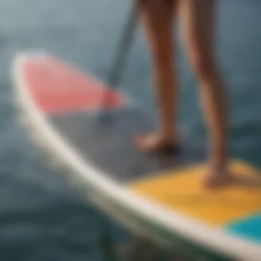 A close-up of a paddleboard highlighting its unique features like fins and deck pad.