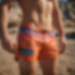 Colorful graphic board shorts showcased on a sandy beach