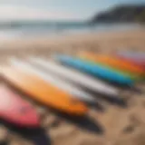 A diverse selection of beginner surfboards lined up on the beach