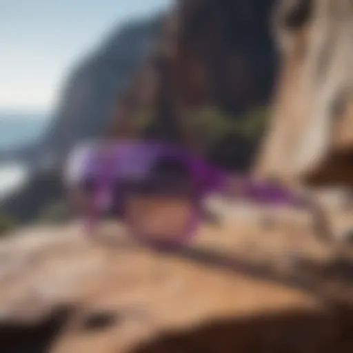 Unique light purple sunglasses perched on rocky cliff overlooking extreme sports terrain