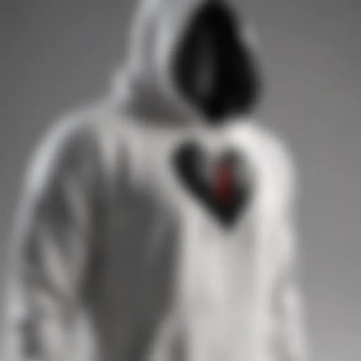 Minimalist black broken heart hoodie against white background