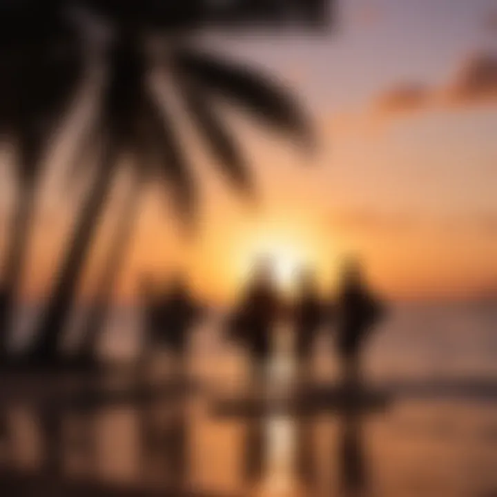 Sunset silhouette of surfers gathered around a bonfire at Moorea Surf Inn