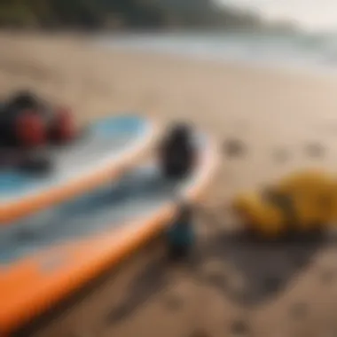 A close-up of paddleboard equipment laid out on the beach