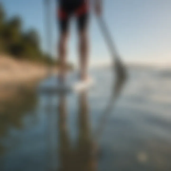 An individual measuring their height against a paddle board for size selection.