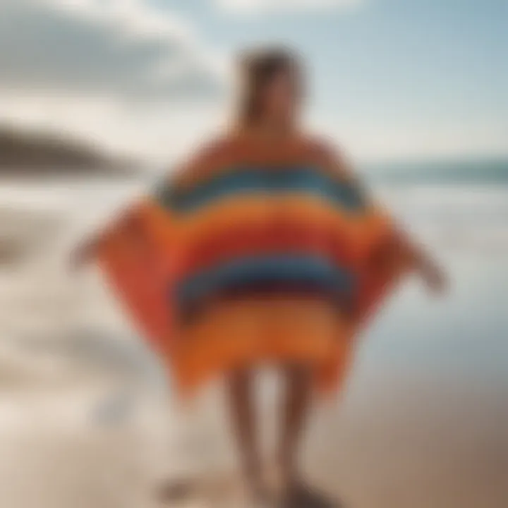 A vibrant Slowtide surf poncho displayed on a sandy beach