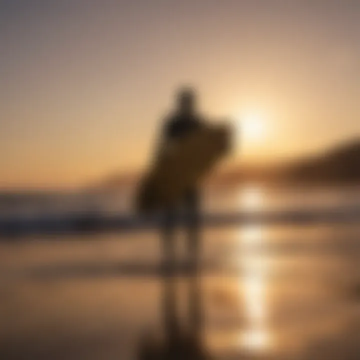 Sunset silhouette of a surfer carrying a 7ft surfboard