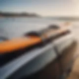 A close-up of a surf strap securing a surfboard on a car roof