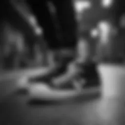 Black and white Converse shoes on a skateboard