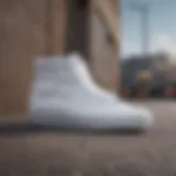 A close-up view of white skate vans on a textured urban surface, showcasing their design and material.