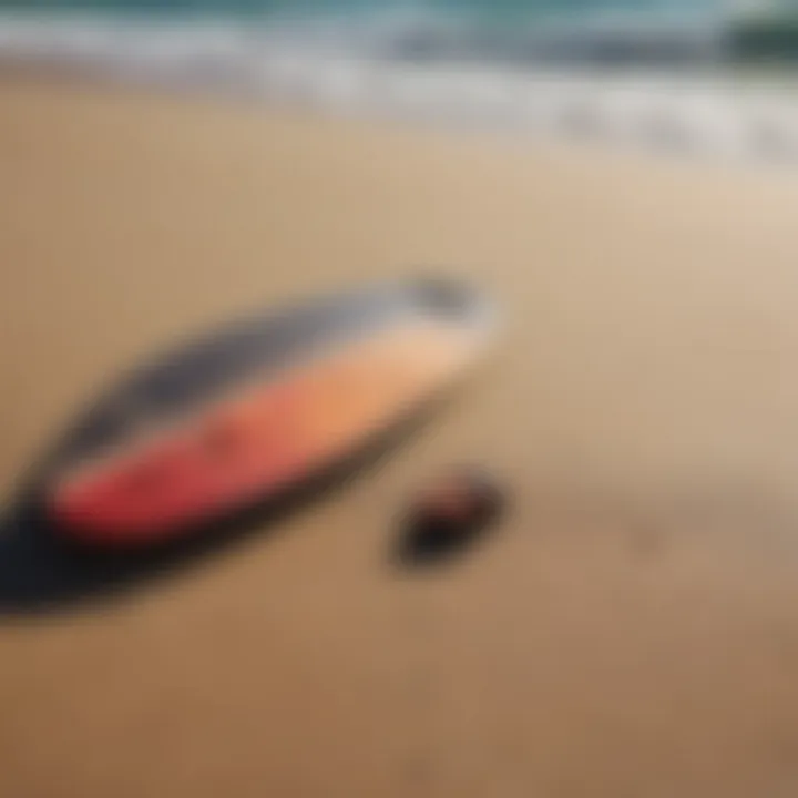 Close-up of essential skimboarding equipment laid out on the sand