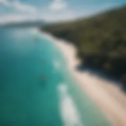 Aerial view of kiteboarders gliding over crystal clear turquoise waters