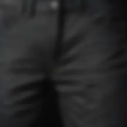 A close-up of washed out black jeans showcasing texture and wear.